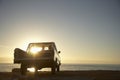 Couple In Pick-Up Truck Enjoying Sunset