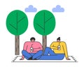 Couple on picnic in park. Man and woman sitting on blanket on grass under trees Royalty Free Stock Photo