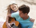 Couple, picnic and playing guitar for romance, love or song in outdoor bonding, fun or relaxing together in nature. Man Royalty Free Stock Photo