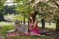 Portrait of Couple Picnicking in Orchard Royalty Free Stock Photo