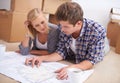 Couple, planning and house blueprints with moving boxes for home renovation, floor plan or property investment. Man Royalty Free Stock Photo