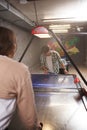 Couple playing air hockey together at college campus