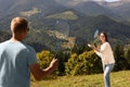 Couple playing badminton in mountains on sunny day Royalty Free Stock Photo