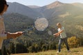 Couple playing badminton in mountains on sunny day Royalty Free Stock Photo