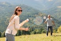 Couple playing badminton in mountains on sunny day Royalty Free Stock Photo