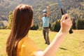 Couple playing badminton in mountains on sunny day Royalty Free Stock Photo