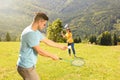 Couple playing badminton in mountains on sunny day Royalty Free Stock Photo