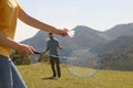 Couple playing badminton in mountains on sunny day Royalty Free Stock Photo