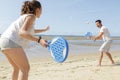 couple playing beach tennis game on sand Royalty Free Stock Photo