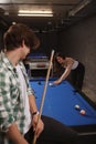 Couple playing billiard on a pool table Royalty Free Stock Photo