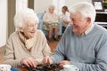 Couple Playing Dominoes At Day Care Centre