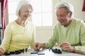 Couple playing dominos in living room smiling