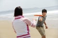 Couple Playing Frisbee On Beach