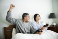 A couple playing game together in bed Royalty Free Stock Photo