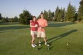 Couple Playing Golf on Course - Horizontal Royalty Free Stock Photo