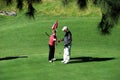 Couple playing golf, Spain.