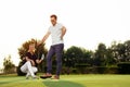 Couple playing golf together on golf course Royalty Free Stock Photo