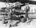 Couple playing with propeller on plane Royalty Free Stock Photo