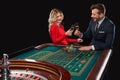 Couple playing roulette wins at the casino. Royalty Free Stock Photo