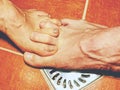 Couple playing in shower, feet on rural floor Royalty Free Stock Photo