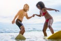 Couple playing surfboard on the beach in weekend activity Royalty Free Stock Photo