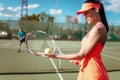 Couple playing tennis on outdoor court Royalty Free Stock Photo