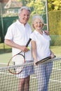 Couple playing tennis and smiling Royalty Free Stock Photo