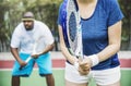 Couple playing tennis together outdoors Royalty Free Stock Photo
