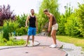 Couple playing together miniature golf outdoors Royalty Free Stock Photo