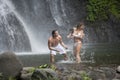 Couple Playing Under Waterfalls Royalty Free Stock Photo