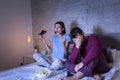 Couple playing video games in bed Royalty Free Stock Photo