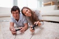 Couple playing video games on the floor Royalty Free Stock Photo