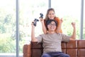 Couple playing video games at home,sitting on sofa Royalty Free Stock Photo