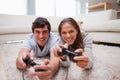 Couple playing video games in the living room Royalty Free Stock Photo