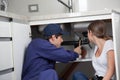 Couple plumbers fixing the pipes Royalty Free Stock Photo