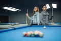 couple of pool players standing beside the pool bring their cue stick Royalty Free Stock Photo