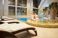 Couple in the pool resting spa center. Royalty Free Stock Photo