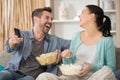 Couple with popcorn watching tv together Royalty Free Stock Photo