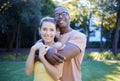 Couple in portrait, date in park with hug and outdoor in nature, love and commitment with interracial relationship Royalty Free Stock Photo