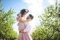 Couple portrait of a girl and guy looking for a wedding dress, a pink dress flying with a wreath of flowers on her head on a backg Royalty Free Stock Photo