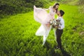 Couple portrait of a girl and guy looking for a wedding dress, a pink dress flying with a wreath of flowers on her head on a backg Royalty Free Stock Photo