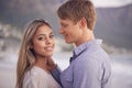 Couple, portrait and love in touch by beach, ocean waves and peace for romance in relationship. People, affection and Royalty Free Stock Photo