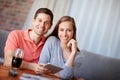 Couple, portrait and relax in home with tablet for streaming online for movies or films, videos and social media memes Royalty Free Stock Photo