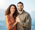 Couple, portrait and smile at beach, love and excited with holding hands, care and romance on holiday. Man, woman and Royalty Free Stock Photo