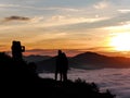 Couple pose for photo at sunrise, Kelimutu volcano, Flores, Indonesia