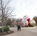 Couple poses to take a selfie with the huge Christmas Ornaments outside of World of Coca Cola in Atlanta, Georgia