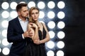 Couple posing against the backdrop of spotlights