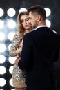 couple posing against the backdrop of spotlights