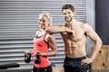 Couple posing with dumbbells Royalty Free Stock Photo