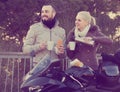 Couple posing near motor bike with sandwitches and coffee Royalty Free Stock Photo